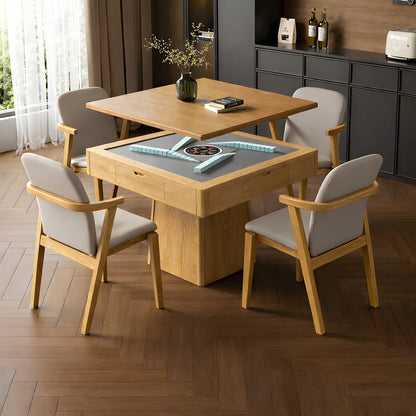 A mid-century modern AUTOJONG automatic mahjong table in  oak, showcasing its convertible design with the wooden tabletop partially lifted to reveal a sleek grey felt playing surface and automatic tile-shuffling mechanism. It is surrounded by four matching beige chairs on a dark wood herringbone floor, highlighting its dual-functionality as both a premium dining table and a high-tech game table.